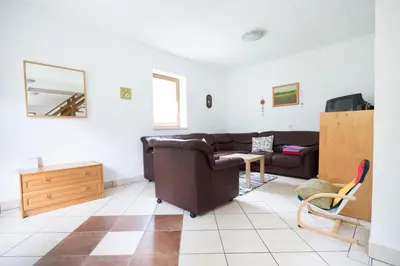 a living room with a couch and a table at Yellow house in Trenta