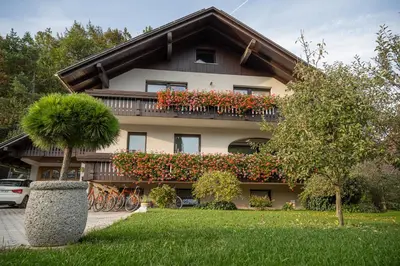 a building with a balcony with flowers on it at Apartments Artemida in Bled