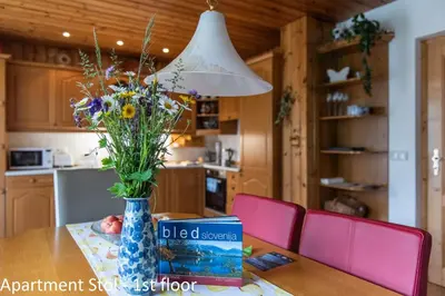 a vase of flowers on a table in a kitchen at Apartments Artemida in Bled