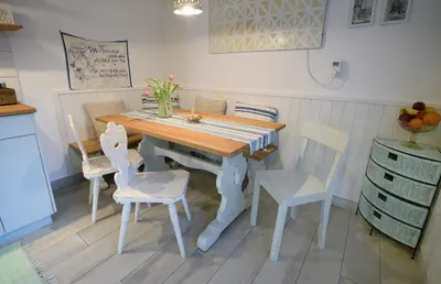 a kitchen with a wooden table and chairs at Apartment Micnek Bled in Bled