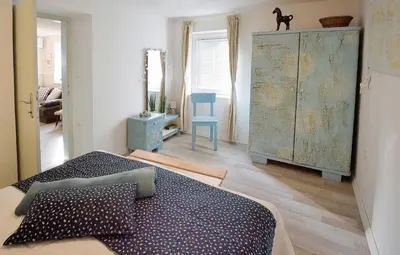 a bedroom with a bed and a dresser in a room at Apartment Micnek Bled in Bled