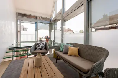a living room with a couch and a table at Rožna Dolina Apartment in Ljubljana