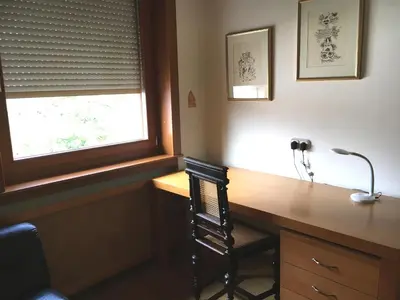 a home office with a desk and a window at Rožna Dolina Apartment in Ljubljana