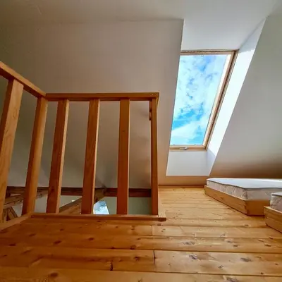 an attic room with a bed and a window at Entire Loft close to Beautiful Logar Valley in Rečica ob Savinji