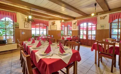 a dining room with tables with red napkins on them at Prenočišča Miklavčič in Nova Vas