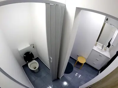 a small bathroom with a toilet and a mirror at The Jungle Apartments and Rooms (Vila Džungla) in Bled