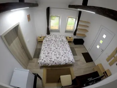an overhead view of a bedroom with a bed and stairs at The Jungle Apartments and Rooms (Vila Džungla) in Bled
