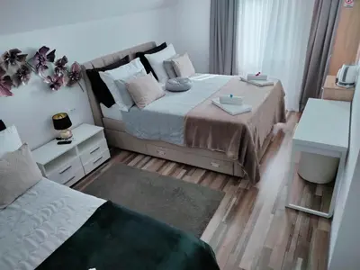 a small bedroom with a bed and a couch at Vila Lemic Postojna in Postojna