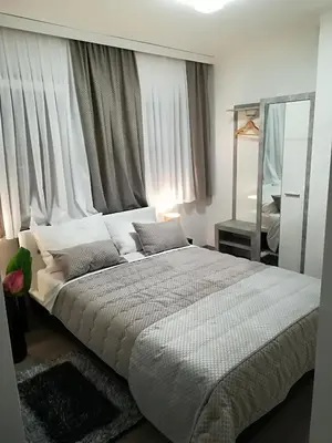 a bedroom with a large bed in front of a window at Vila Lemic Postojna in Postojna