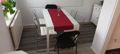 a table with chairs and a red blanket on it at ApartmentMR in Maribor