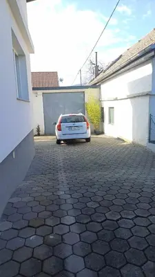 a car parked in a parking lot next to a garage at ApartmentMR in Maribor