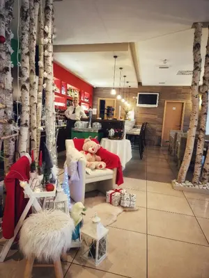 a teddy bear sitting on a couch in a store at Hotel Bela Krajina in Metlika