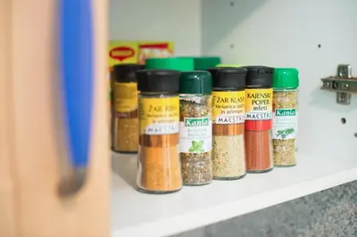 a row of spices on a shelf at Apartment Zoya in Kranjska Gora