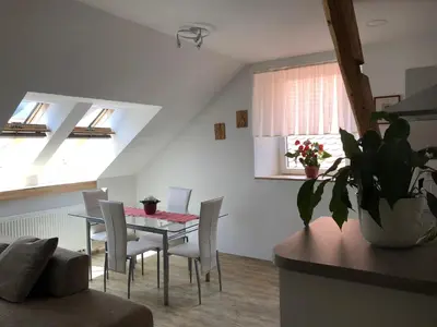 a kitchen and dining room with a table and chairs at Apartma Linhartov trg in Radovljica