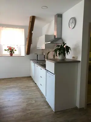 a kitchen with white cabinets and a stove at Apartma Linhartov trg in Radovljica