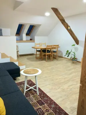 a living room with a couch and a table at Apartma Linhartov trg in Radovljica