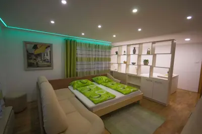a living room with a couch and a table at apartma mojca in Bohinj