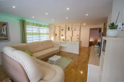a living room with a couch and a table at apartma mojca in Bohinj