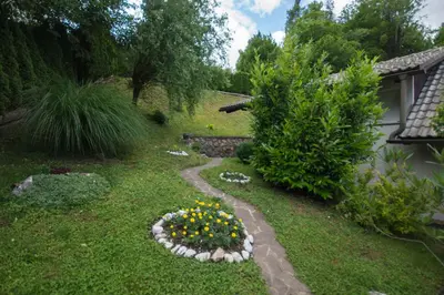 a garden with a flower arrangement in the grass at apartma mojca in Bohinj