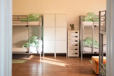 a room with two bunk beds and a closet at Fluxus Hostel in Ljubljana