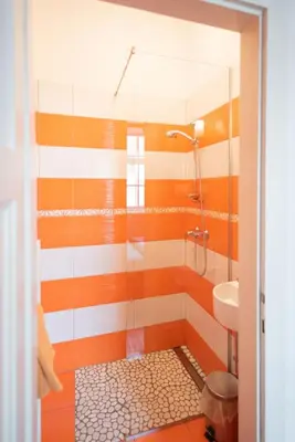 a bathroom with a shower and a sink at Fluxus Hostel in Ljubljana
