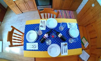 a table with blue and white plates on it at Apartment and Garden house among the mountains in Podbrdo