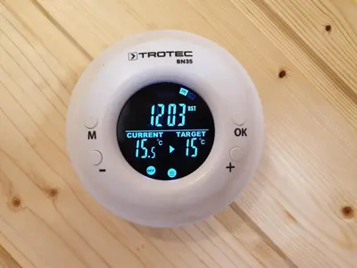 a clock on a wall with a clock on it at Apartment and Garden house among the mountains in Podbrdo