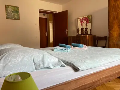 a bed with two towels on top of it at Apartment and Garden house among the mountains in Podbrdo