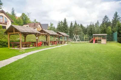 a park with a picnic shelter and a playground at Hotel Rakitna in Rakitna