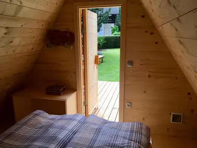 a bedroom in a wooden cabin with a bed at Glamping houses J-Max in Bled