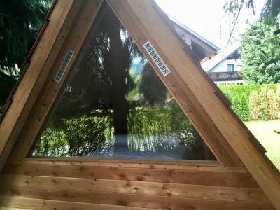 a window in the roof of a wooden house at Glamping houses J-Max in Bled