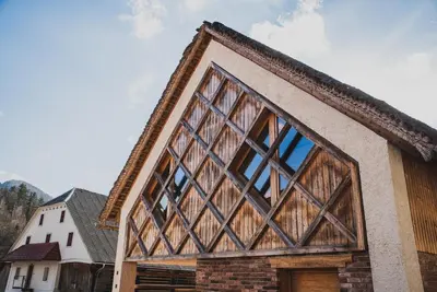 a house with a large window on the side of it at Farm stay Žurej in Šentjur
