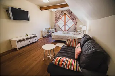 a living room with a couch and a bed at Farm stay Žurej in Šentjur