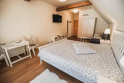 a bedroom with a bed and a table and a desk at Farm stay Žurej in Šentjur