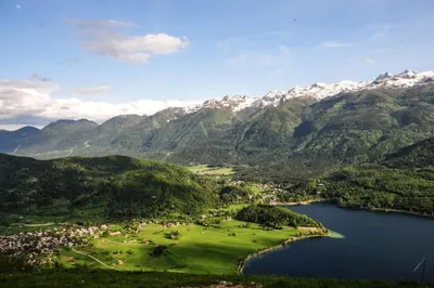 an aerial view of a valley with a lake and mountains at Gorska hiška Vogar nad Bohinjskim jezerom in Bohinj