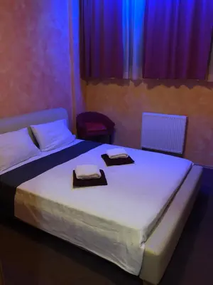 a bedroom with a bed with two towels on it at Motel Sofia in Sežana