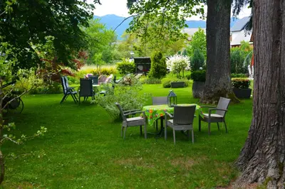 a group of chairs and tables in a yard at Vila Ana Generoes Bled in Bled