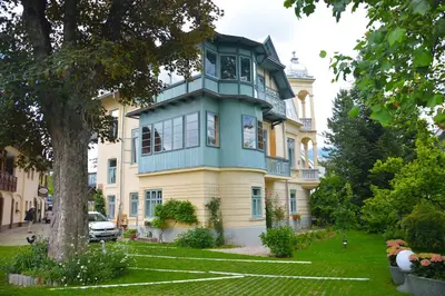 a blue and yellow house with a tree at Vila Ana Generoes Bled in Bled