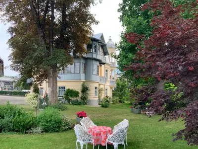 a table and chairs in front of a house at Vila Ana Generoes Bled in Bled