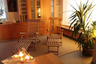 two chairs and a table in a room with a plant at Vila Ana Generoes Bled in Bled