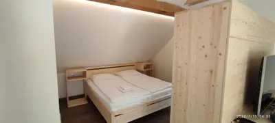 a small room with a small bed in a attic at Apartments Lake Bohinj in Bohinj