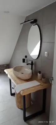 a bathroom with a sink and a mirror on a table at Apartments Lake Bohinj in Bohinj