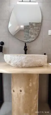 a bathroom sink with a mirror on top of it at Apartments Lake Bohinj in Bohinj