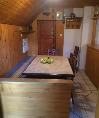 a kitchen with a table with a bowl of fruit on it at Mountain apartment Uskovnica in Bohinj