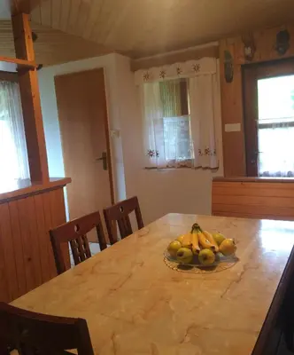 a dining room table with a bowl of fruit on it at Mountain apartment Uskovnica in Bohinj