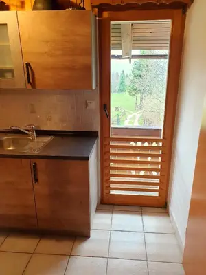 a kitchen with a window and a sink and a counter at Mountain apartment Uskovnica in Bohinj
