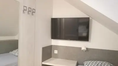a room with a flat screen tv on the wall at H2O Hostel in Ljubljana