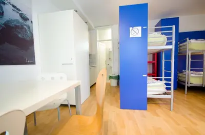 a room with a desk and bunk beds at H2O Hostel in Ljubljana