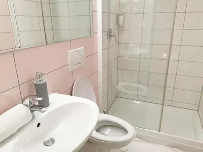 a bathroom with a sink and a toilet and a shower at Rooms Sincere 1830 in Ljubljana