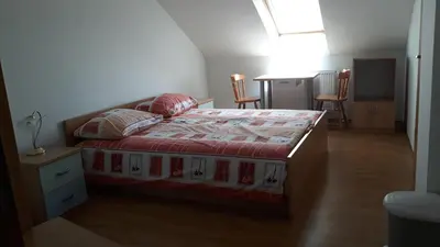 a bedroom with a bed and a table and chairs at Tourist Farm Lavrič in Woditz